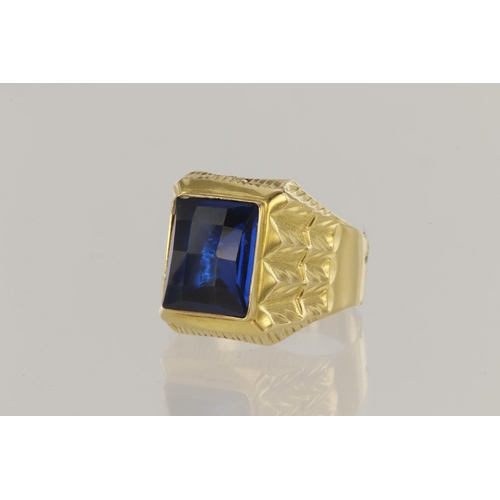 62 - 18ct yellow gold hollow signet style ring set with fancy cut rectangular blue glass 