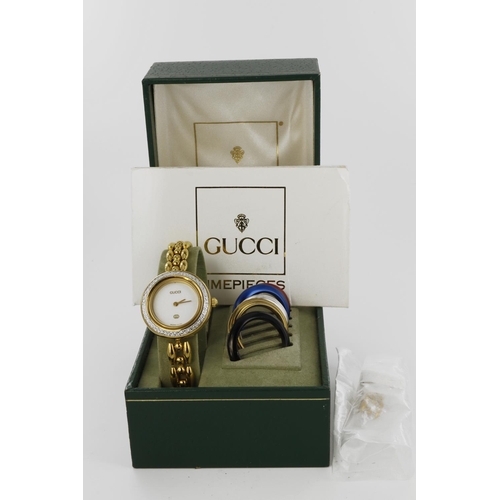 630 - Ladies Gucci wristwatch, with interchangeable coloured bezel inserts. In its original box with paper... 