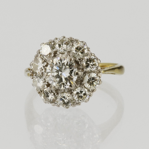 64 - 18ct yellow gold cluster ring set with central round brilliant cut diamond weighing approx. 0.70ct, ... 