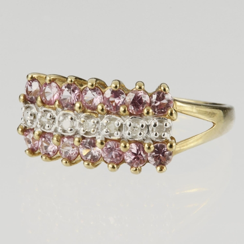 67 - 9ct yellow gold three row ring set with fourteen round pink sapphires measuring approx. 2mm diameter... 