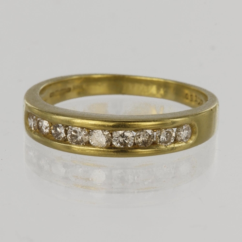 68 - 18ct yellow gold half eternity ring set with nine round brilliant cut diamonds in a channel setting,... 