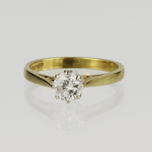 76 - 18ct yellow gold solitaire ring set with a round brilliant cut diamond in an eight claw white gold m... 