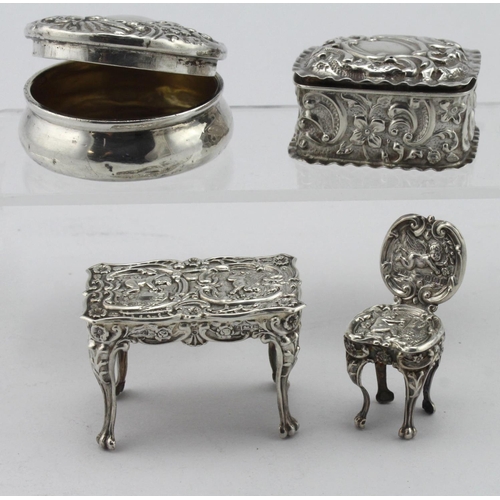 879 - Two silver trinket/pill boxes hallmarked Birm. 1900 & 1903 and a silver miniature chair & silver tab... 