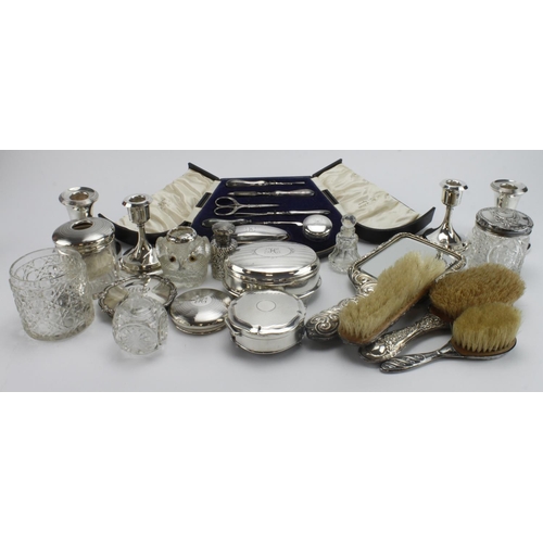 898 - Mixed Silver. A collection of various silver items, including candlesticks, silver lidded jars, vani... 