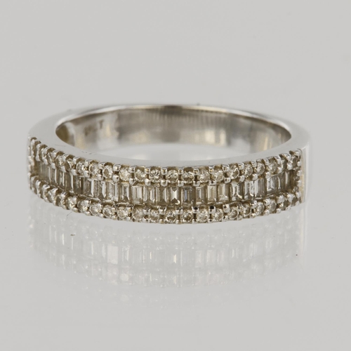 94 - 18ct white gold half eternity ring set with a central row of twenty five baguette cut diamonds borde... 