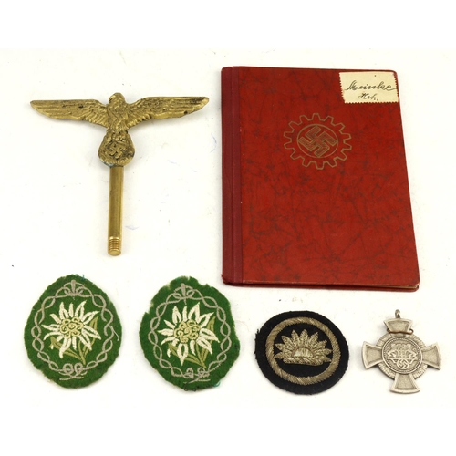 1101 - German WW2 booklet, cloth and metal badge brass eagle etc.