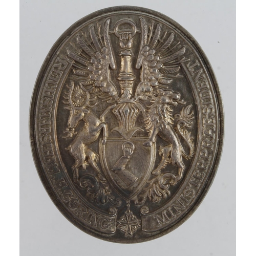 1117 - Herman Goring interest - small white metal plaque (39mm) with Gorings family crest surrounded with '... 