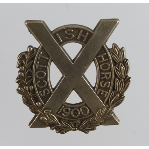 146 - Badge a Scottish Horse 1900 Boer War era white metal cap badge.