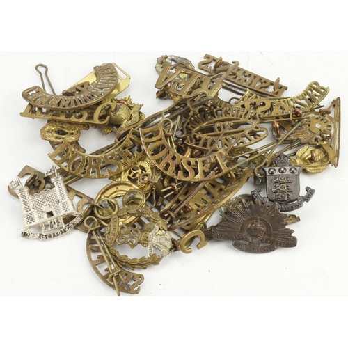 158 - Badges bag of assorted brass shoulder titles, collar badges buttons etc.