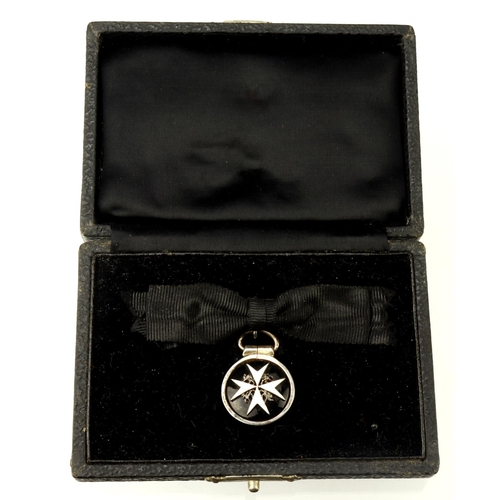 840 - Order of St John serving sister miniature medal on bow as used by women with fitted case.