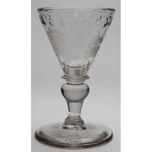 261 - 18th Century glass goblet with exquisite engraved decoration, circa 1720, depicting a figure carryin... 