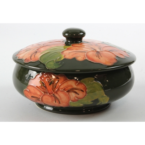 311 - Moorcroft Hibiscus pattern bowl with lid, makers label to base, diameter 12.5cm approx.