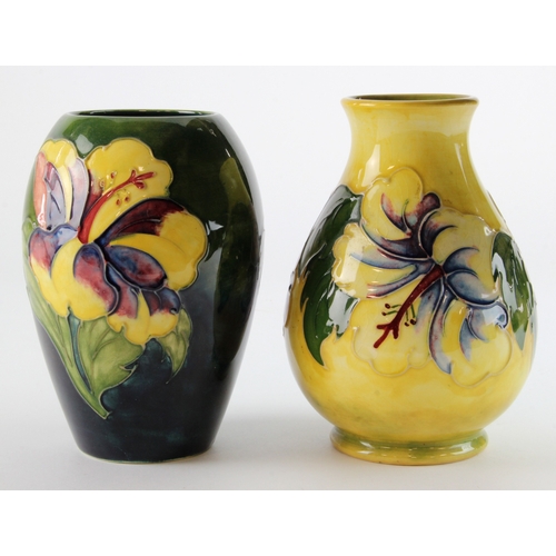 321 - Moorcroft. Two Moorcroft Hibiscus pattern vases, makers marks to base of each, height 13cm approx.