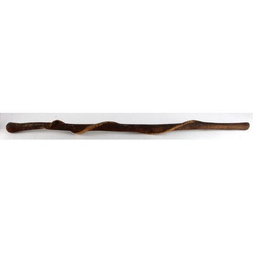 442 - Aboriginal carved stick with coiled snake design, length 95cm approx.