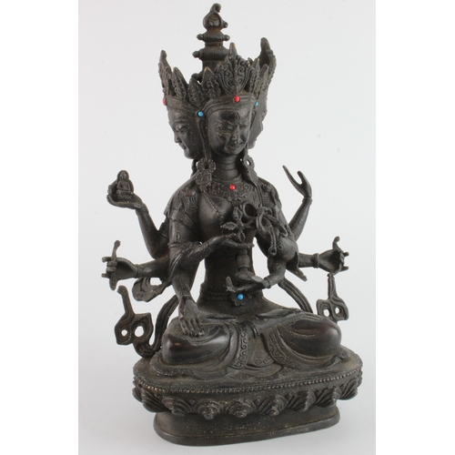 459 - Bronze Tibetan figure with three faces, height 30cm approx.