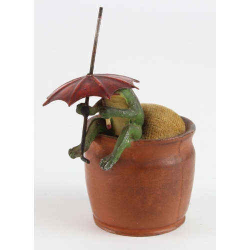 466 - Cold painted bronze novelty pin cushion, depicting a frog sat on a plant pot holding an umbrella, he... 