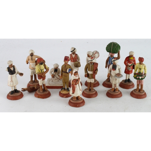 476 - Figures. A group of clay figures thought to of been brought back by a serviceman during WWI, height ... 