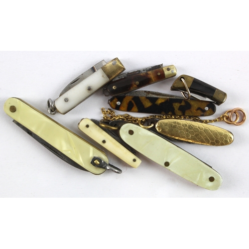 493 - Miniature Penknives. A group of eight miniature penknives, including a 15ct gold example