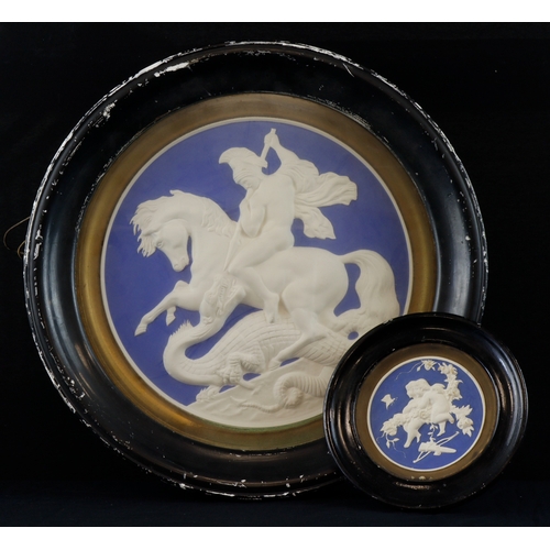 503 - Plaques. Two framed & glazed plaster blue & white wall plaques, one depicting George & the Dragon, l... 