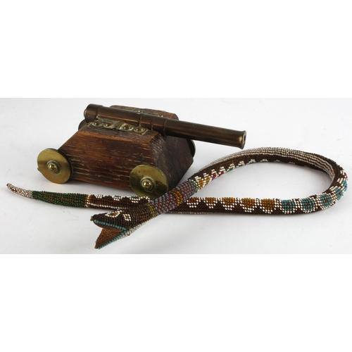 504 - Prisoner of War beaded snake, length 64cm approx., together with a brass & wood cannon (possibly Tre... 