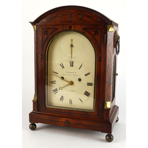 318 - Mahogany mantel clock with inlaid decoration and brass mounts, raised on four ball feet, dial reads ... 