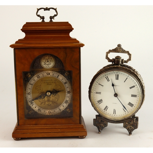 320 - Clocks. Two various clocks, including a silver plated circular clock on four legs, dial with Roman n... 