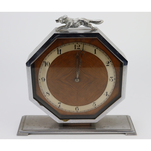 323 - Hunting interest. An octagonal mantel clock with fox finial, engraved to base 'Presented to Miss Jan... 