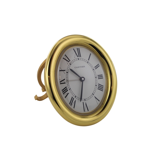 327 - Cartier gold plated desk clock of upright oval form. The white dial with Roman numerals, quartz move... 