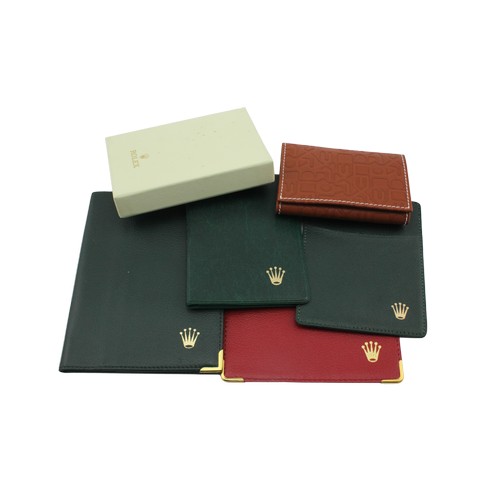 333 - Assortment of Rolex accessories, to include a boxed brown leather wallet and four assorted card/book... 