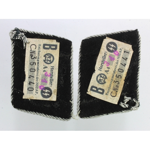 1086 - German SS OBERSCHUTZE pair of collar tabs both with manufacturers paper label on the back.