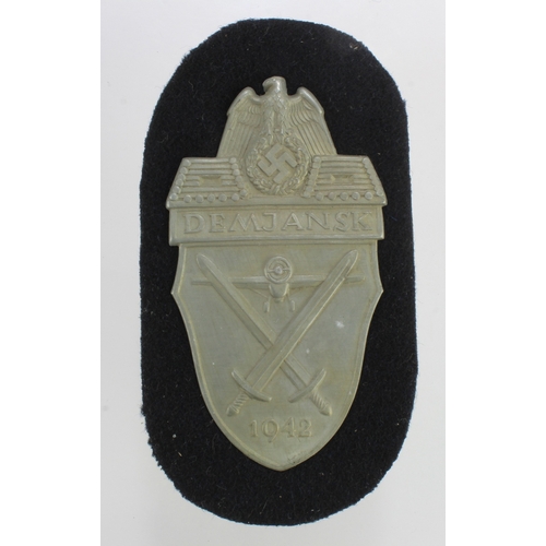 1152 - German WW2 DEMJANSK arm shield unissued.