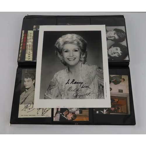 7 - Autographs. A collection of various signed pictures contained in an album, signers include Marty Wil... 