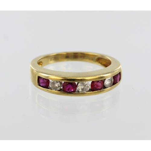 10 - 18ct yellow gold channel set half eternity ruby and diamond ring, four round rubies, three round bri... 