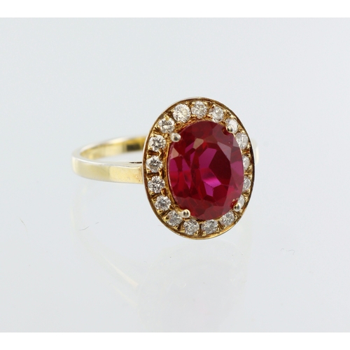 100 - 18ct yellow gold red stone and diamond cluster ring, central oval red stone 10mm x 8mm, seventeen ro... 