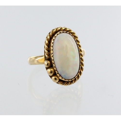 101 - Yellow metal (tests 14ct) opal cabochon ring, opal approx. 14mm x 8mm, finger size H/I, weight 3.5g