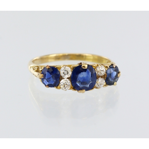 122 - Yellow metal (tests 18ct) sapphire and diamond ring, three graduated round mixed cut sapphires, four... 