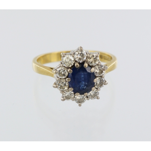 156 - 18ct yellow gold sapphire and diamond cluster ring, centre oval sapphire 7mm x 5mm, ten round brilli... 