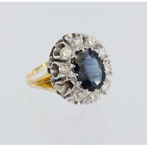 18 - 18ct yellow gold cluster ring, centre oval sapphire 9mm x 7mm, surrounded by ten round brilliant cut... 