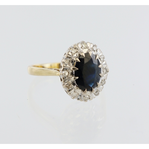 189 - 18ct yellow gold sapphire and diamond cluster, oval sapphire 9mm x 7mm, twelve round brilliant cuts,... 