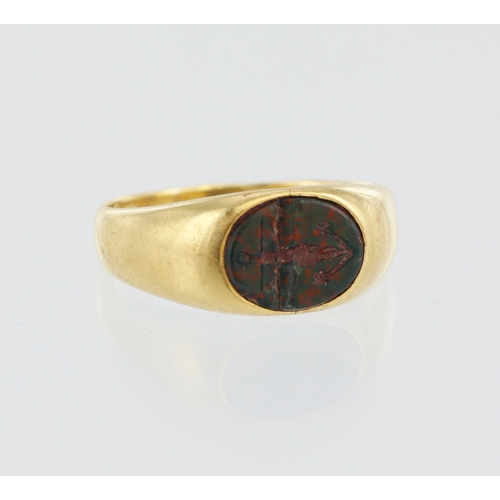 199 - Yellow metal (tests 18ct) signet ring, oval bloodstone carved with anchor, finger size P, weight 4.7... 