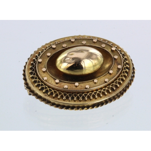 300 - Yellow metal (tests 15ct) hollow memorial brooch, measuring approx. 45mm x 35mm, weight 13.8g