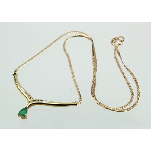 494 - 9ct yellow gold emerald and diamond necklace, single pear shaped emerald dropper, nine round brillia... 