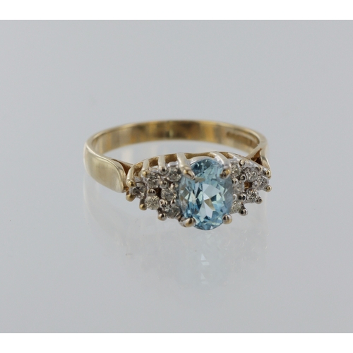 55 - 9ct yellow gold topaz and diamond ring, oval blue topaz 7mm x 5mm, twelve round brilliant cuts, tota... 