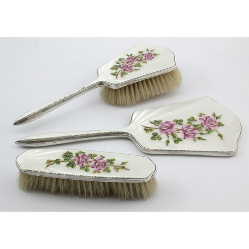 581 - Silver & enamel three piece dressing table set, with floral decoration, hallmarked 'Birmingham 1950'