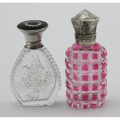 590 - Two silver mounted glass perfume bottles, one with an insert tortoiseshell top with silver marks for... 