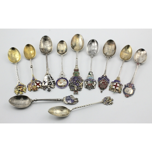 596 - Enamel Teaspoons. Eleven silver & enamel souvenir teaspoons, each with decororation to bowl, includi... 