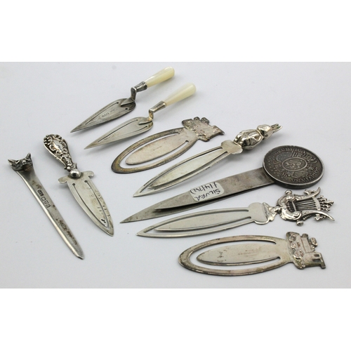 597 - Silver Book Marks. A group of nine silver novelty book marks (mostly hallmarked), including trowels,... 