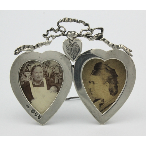 599 - Double heart-shaped silver photograph frame, hallmarked WRC London 1894. Measures 108mm x 92mm appro... 