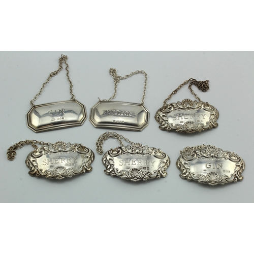 607 - Six silver wine and spirit labels comprising three sherry labels hallmarked Birm. 1979, two gin labe... 