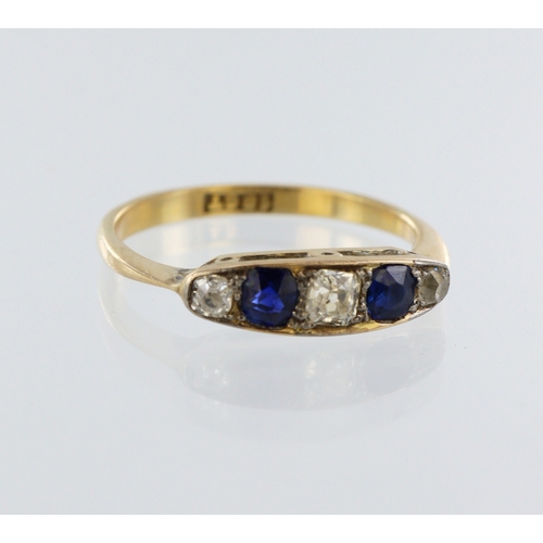 63 - Stamped 18ct yellow gold sapphire and diamond ring, two round sapphires, three round old cuts, total... 